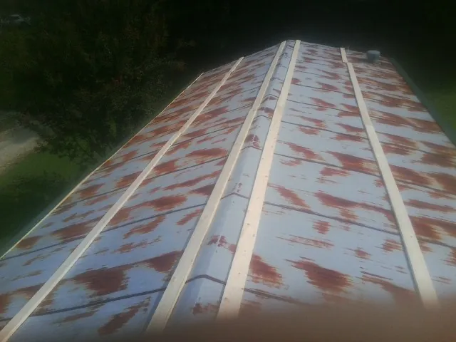 Rusted metal roof panels with new wood purlins before replacement — Storm Damage Roof Repair in Warminster by Roofing Brothers